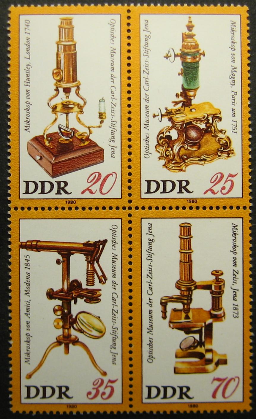 German postage stamps depicting four antique microscopes. Advancements in microscopy were essential to the early study of infectious diseases.
