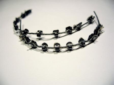 Dental braces, with a powerchain, removed after completion of treatment.
